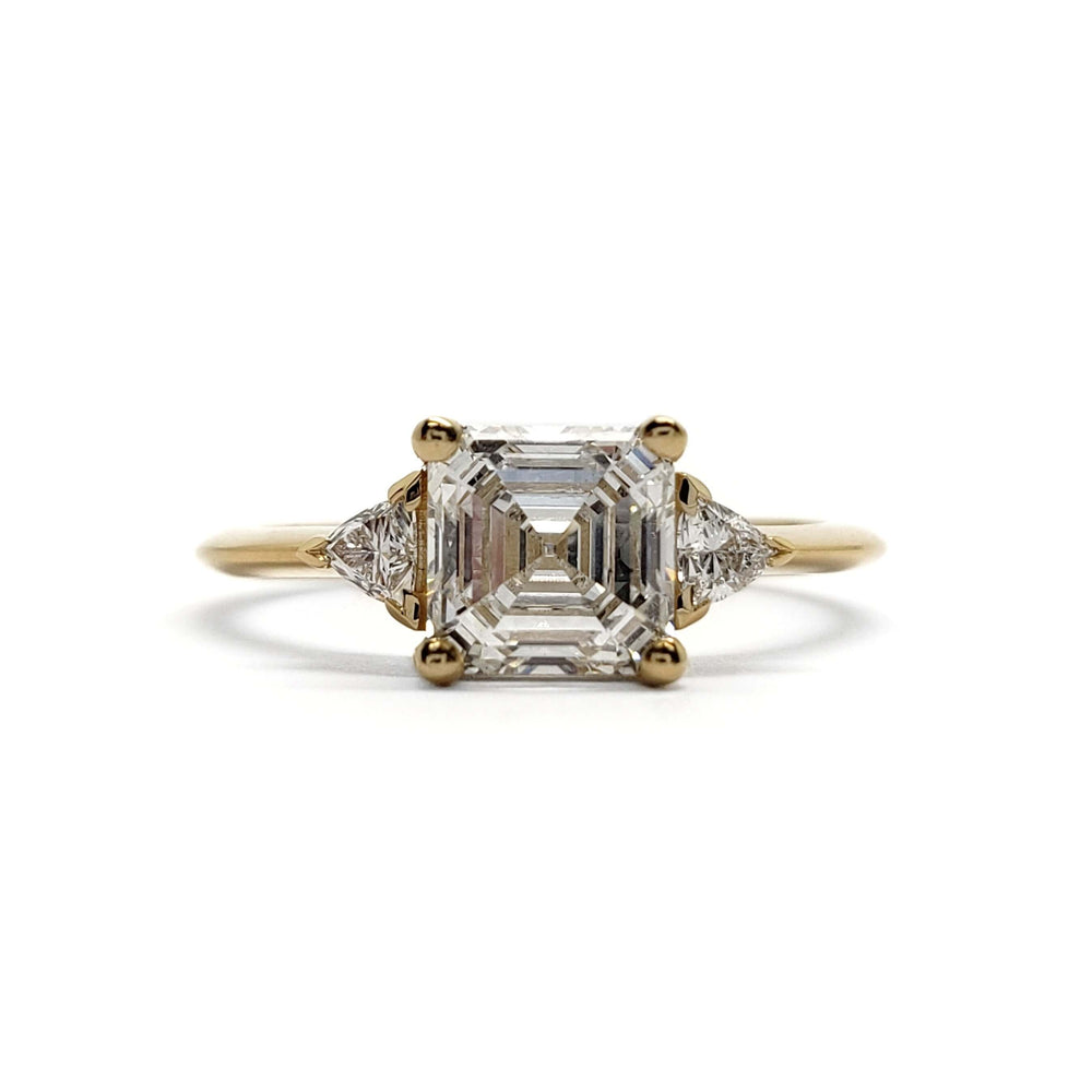 Front view of 14kt yellow gold engagement ring with asscher lab diamond and side stones
