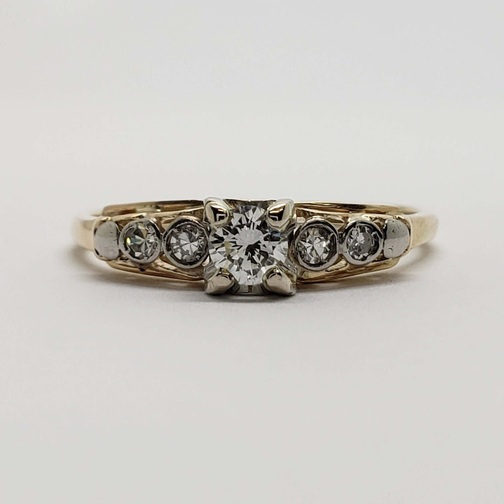 Front view of antique diamond ring in yellow and white gold with transitional cut centre diamond