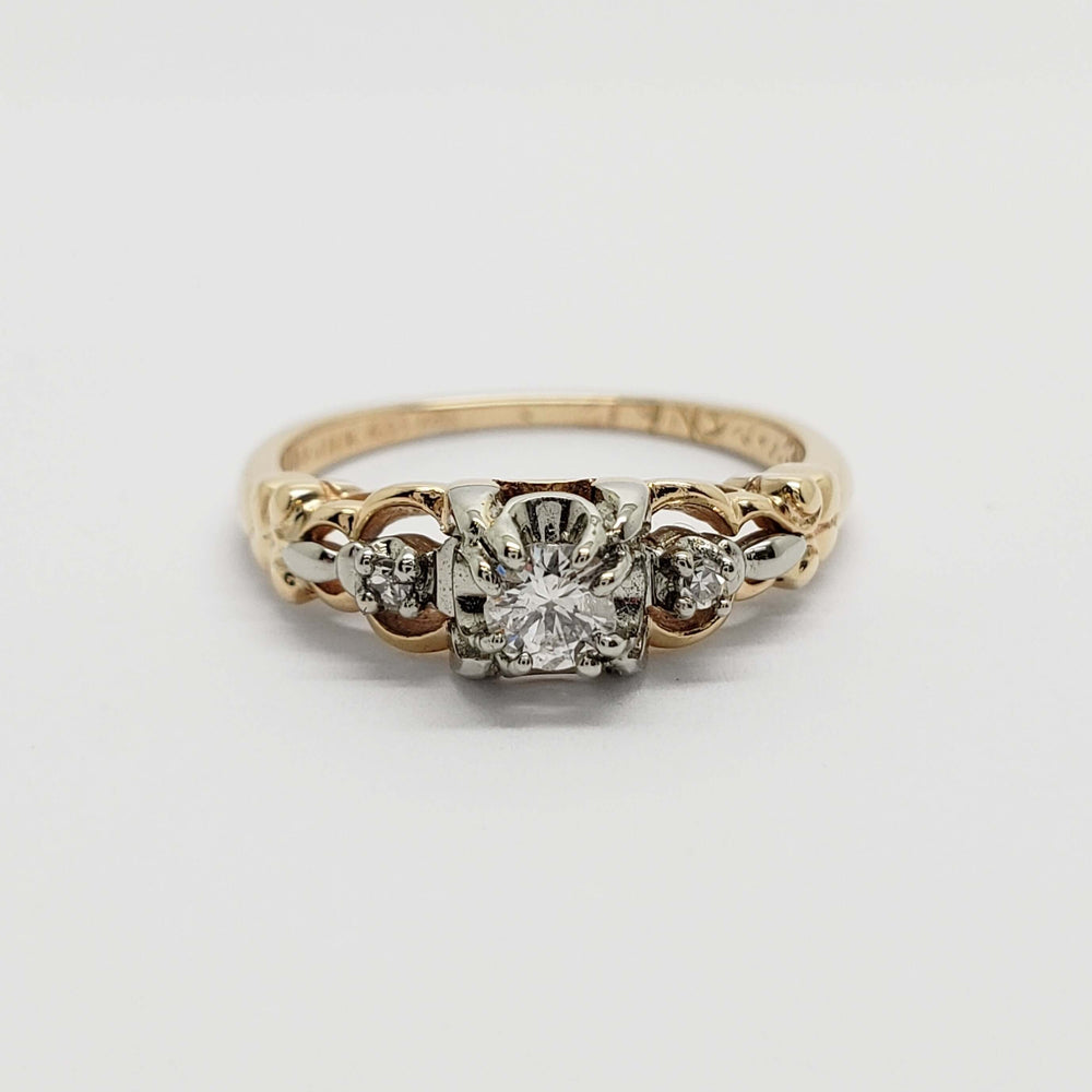 Front view of antique yellow and white gold diamond ring with three diamonds