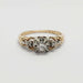 Front view of antique yellow and white gold diamond ring with three diamonds