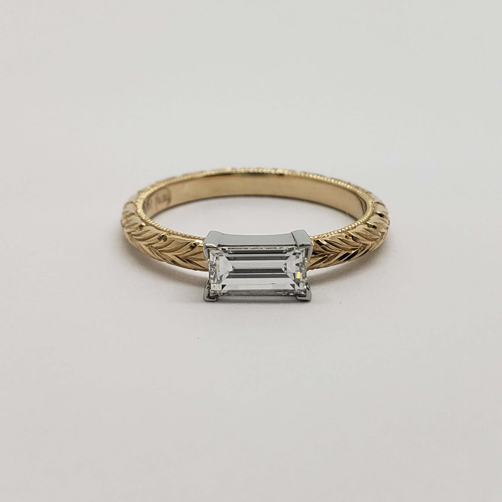 Front view of 14kt yellow and white gold engagement ring with baguette Canadian diamond
