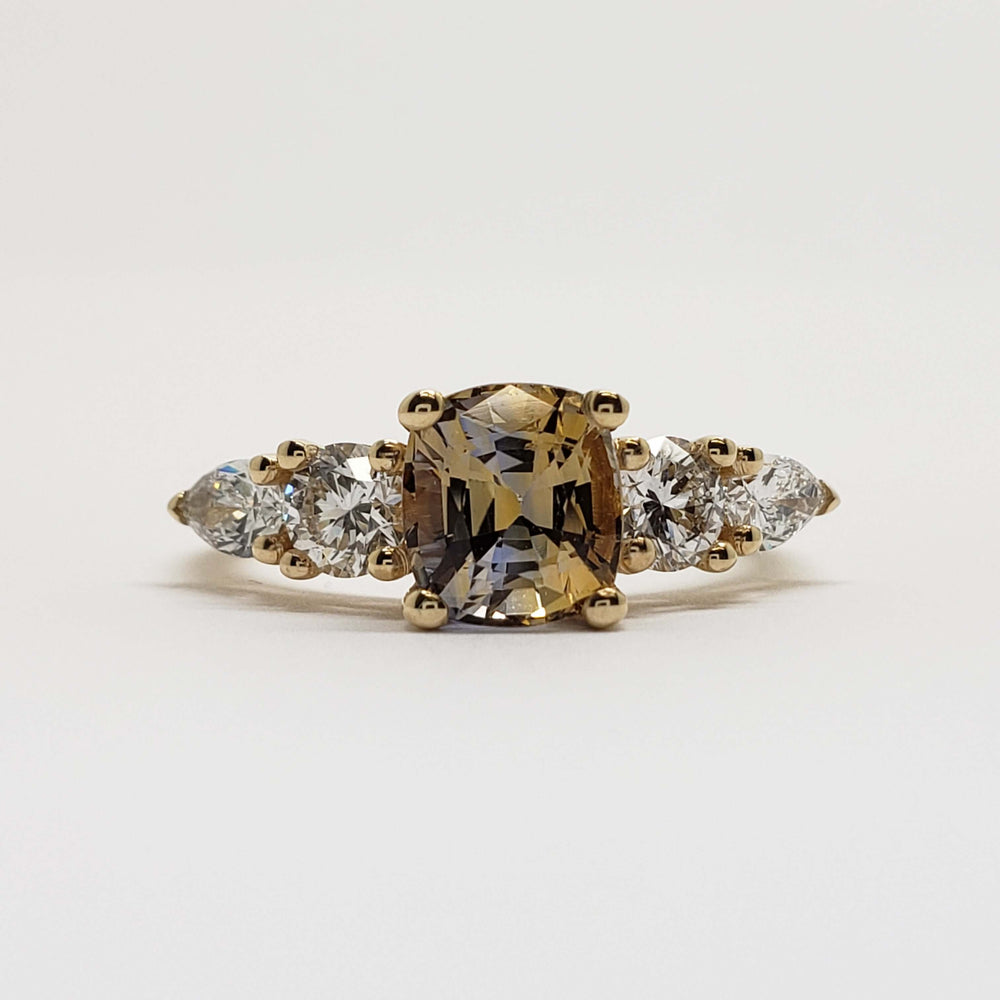 Front view of 14kt yellow gold ring with cushion cut bi-colour sapphire and lab diamonds