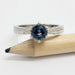 Front view of 14kt white gold Montana sapphire engagement ring with millgrain detail