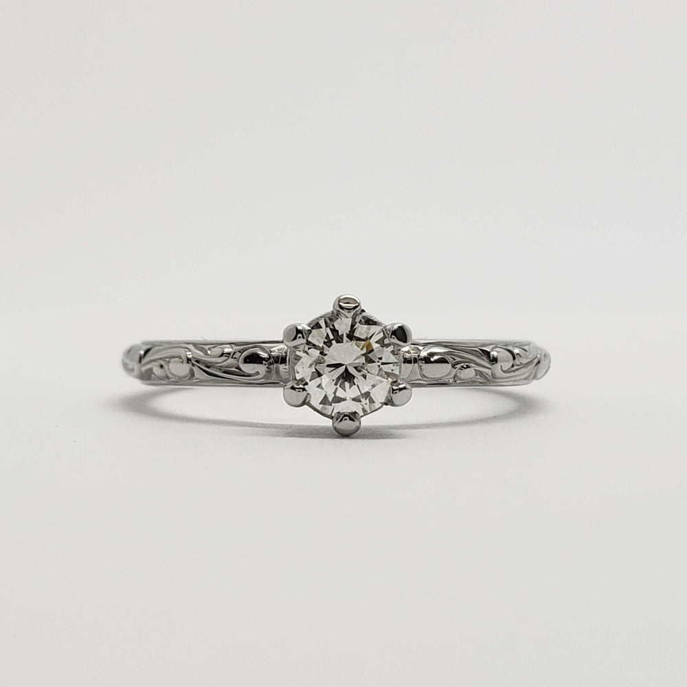 Front view of engraved 14k white gold engagement ring with antique diamond