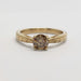 Front view of 14kt yellow gold engagement ring with round champagne diamond and engraved band