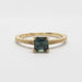 Front view of 14kt yellow gold ring with green asscher cut sapphire and engraved details