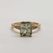 Front view of green sapphire and lab diamond ring in 14kt yellow gold on white background