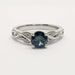 Front view of 14kt white gold ring featuring a blue Montana sapphire and intricate interlace design