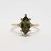 Front view of marquise green sapphire and triangle lab diamond ring in yellow gold