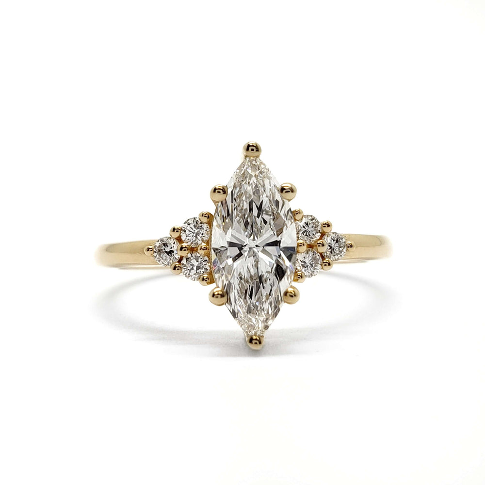 Front view of marquise cut lab diamond engagement ring with accent diamonds in yellow gold