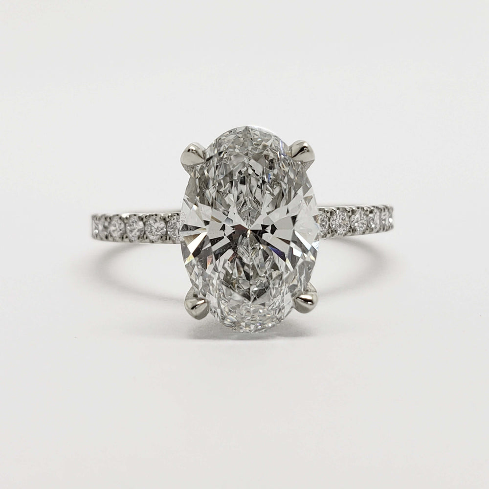 Front view of oval lab diamond engagement ring in 14kt white gold with pave setting
