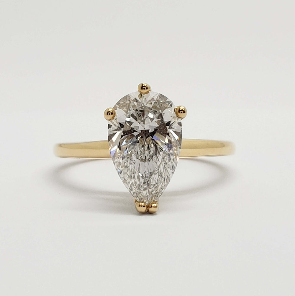 Front view of 14kt yellow gold ring with pear-shaped lab diamond