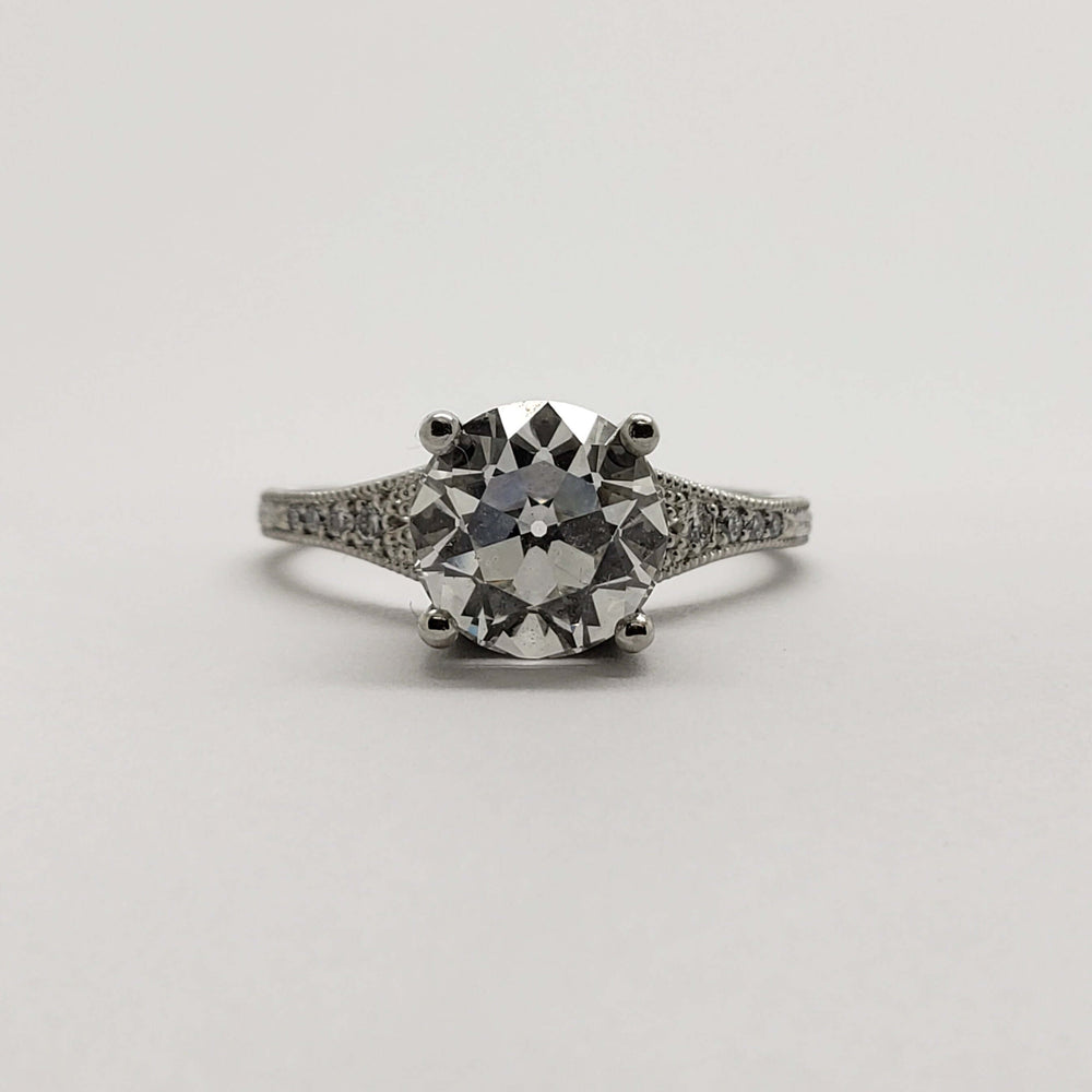 Front view of platinum engagement ring with round lab diamond and pave-set accents