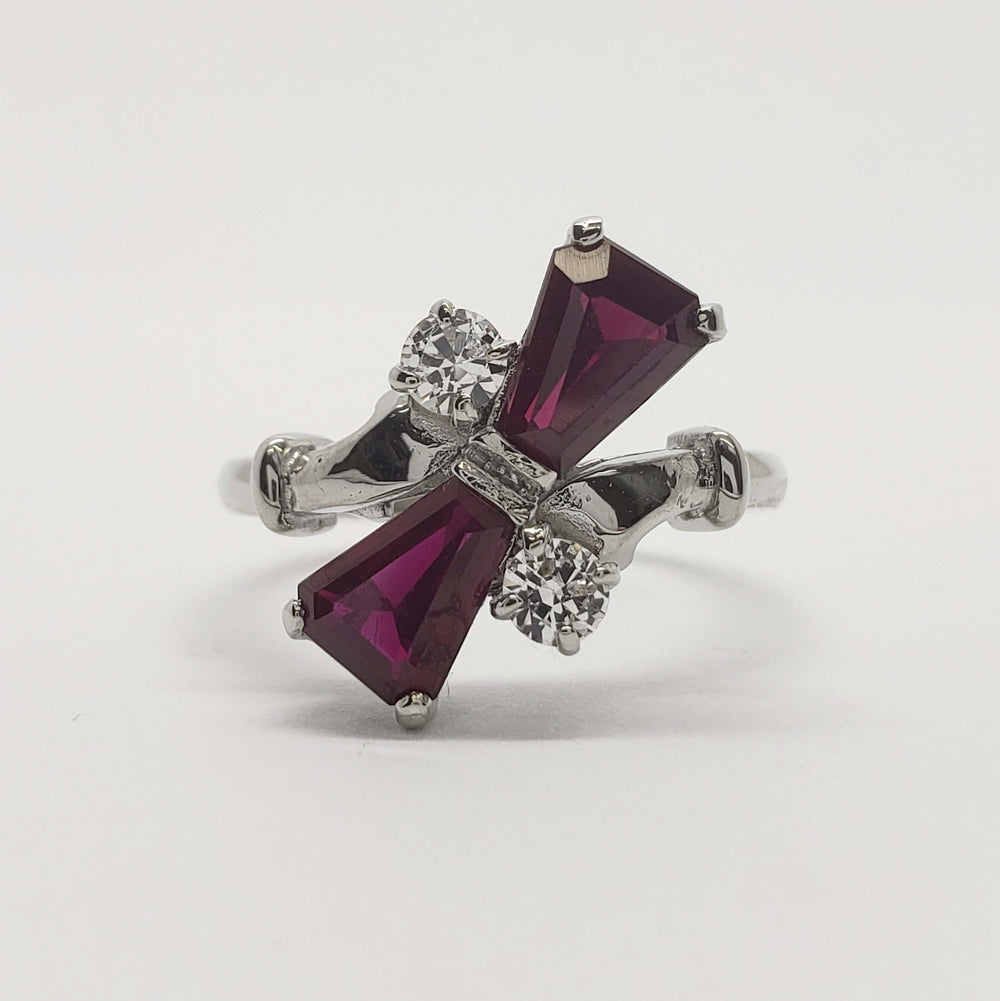 Front view of vintage 10kt white gold ring with red glass and cubic zirconia stones