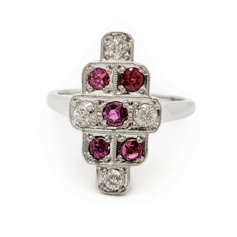 Front view of vintage 18k white gold ring featuring rubies and diamonds