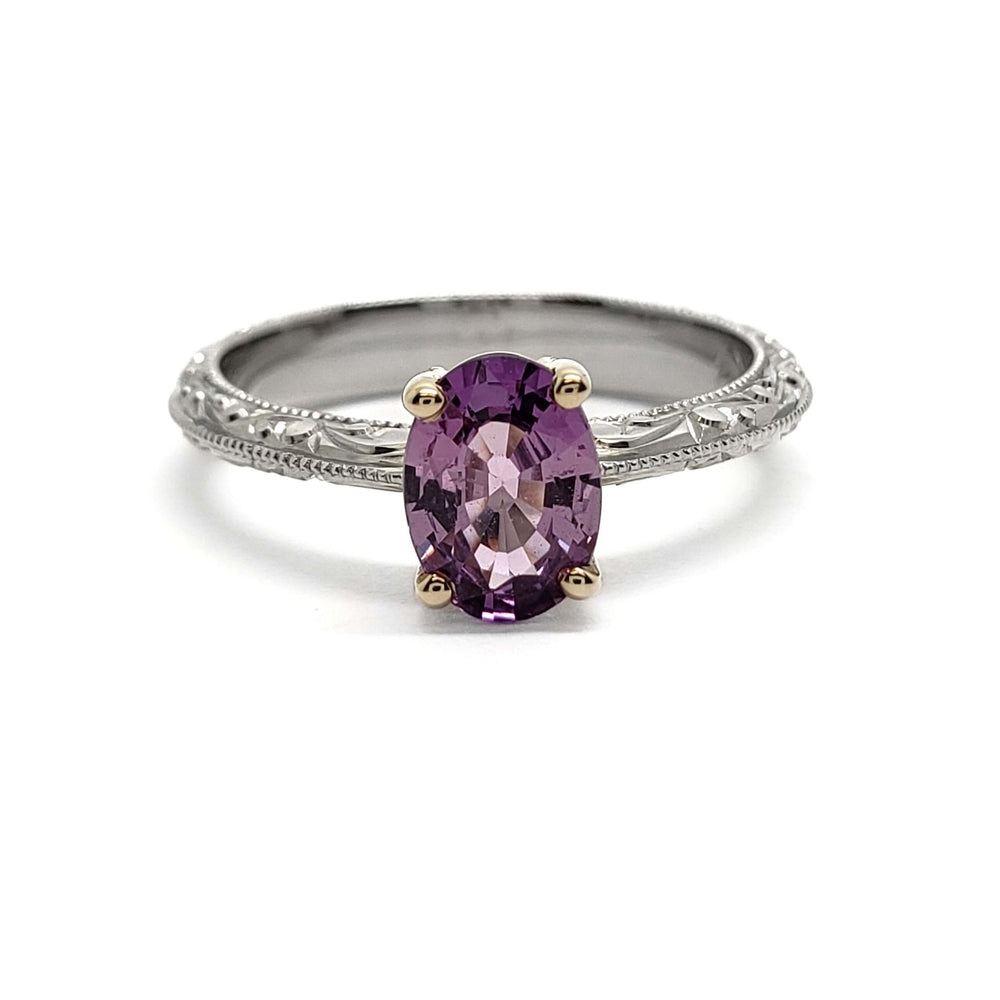 Front view of engraved white and yellow gold ring with oval pink-purple sapphire