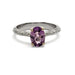 Front view of engraved white and yellow gold ring with oval pink-purple sapphire