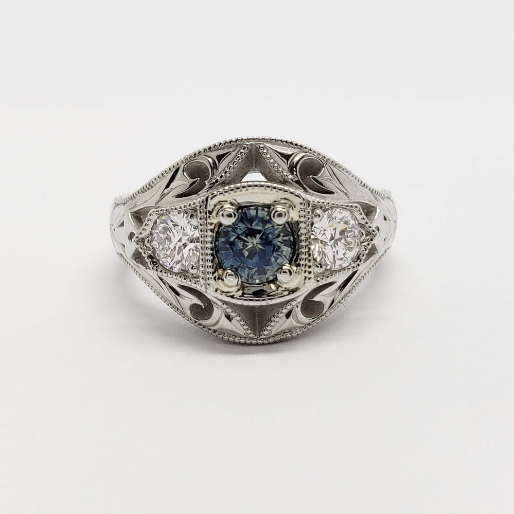Front view of handcrafted white gold ring with Montana sapphire and Canadian diamonds