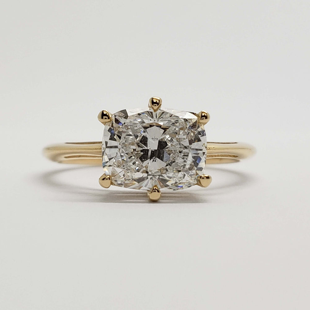 Front view of 14kt yellow gold ring with cushion cut lab diamond in prong setting
