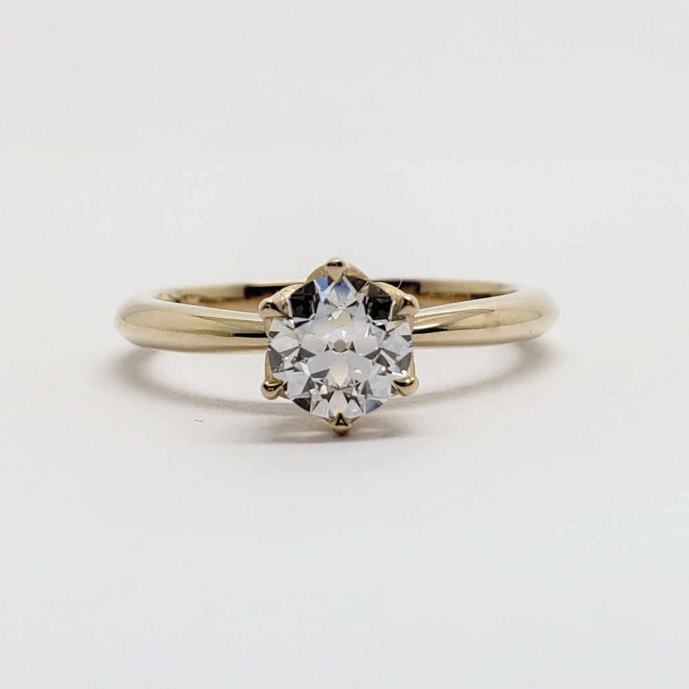 Front view of yellow gold engagement ring with round lab-grown diamond in tulip setting