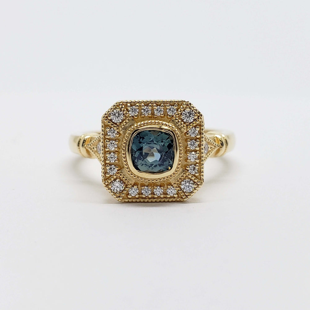 Front view of yellow gold ring featuring cushion cut Montana sapphire and diamond halo