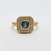 Front view of yellow gold ring featuring cushion cut Montana sapphire and diamond halo