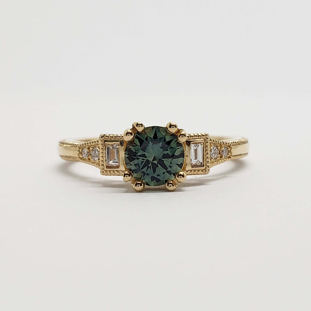 Front view of 14kt yellow gold ring with teal Australian sapphire and baguette lab diamonds
