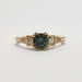 Front view of 14kt yellow gold ring with teal Australian sapphire and baguette lab diamonds