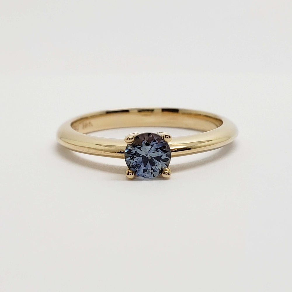 Front view of 14kt yellow gold ring with round blue Montana sapphire