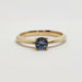 Front view of 14kt yellow gold ring with round blue Montana sapphire