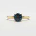 Front view of yellow gold ring with round teal Montana sapphire