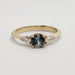 Front view of 14kt yellow gold ring with blue-green sapphire and pear-shaped lab diamonds