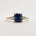 Front view of 14kt yellow gold ring with blue-green sapphire and pear-shaped lab diamonds