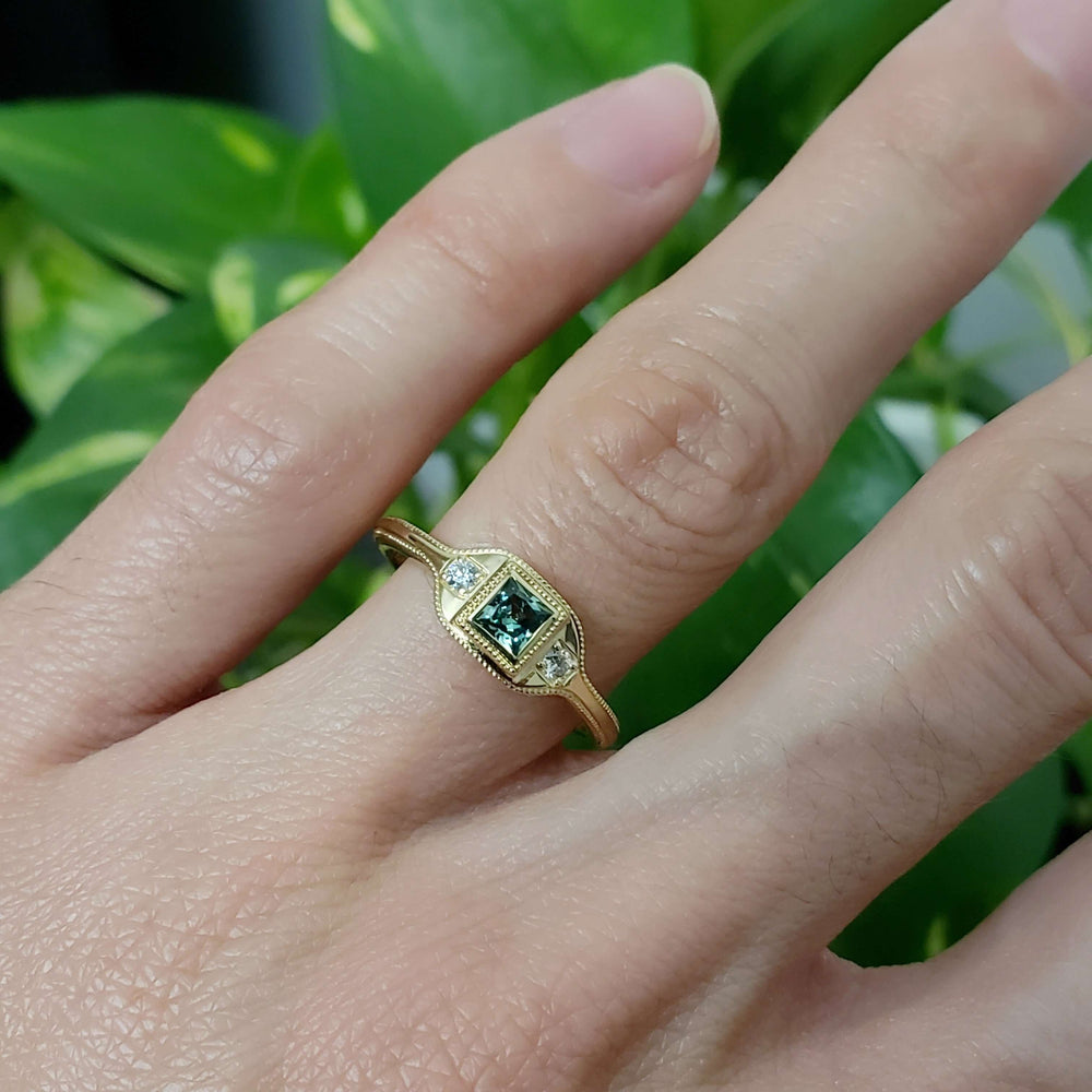 14kt yellow gold green lab sapphire and diamond ring shown on hand
