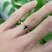 Green sapphire engagement ring in yellow and white gold, worn on hand