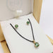 Green tourmaline pendant and stud earrings in 14kt yellow gold, displayed in an Era Design box