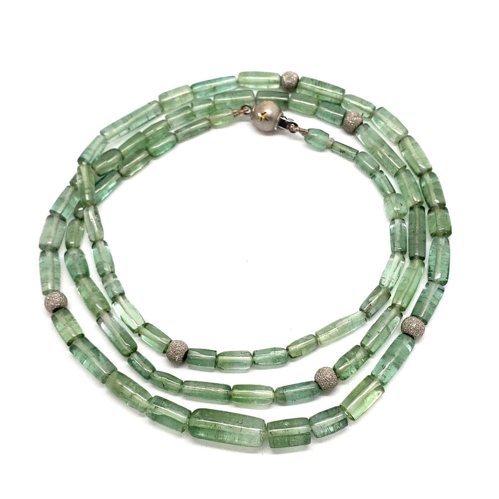 Green tourmaline bead necklace with 14kt white gold beads, shown coiled in a circle
