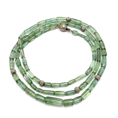 Green tourmaline bead necklace with 14kt white gold beads, shown coiled in a circle