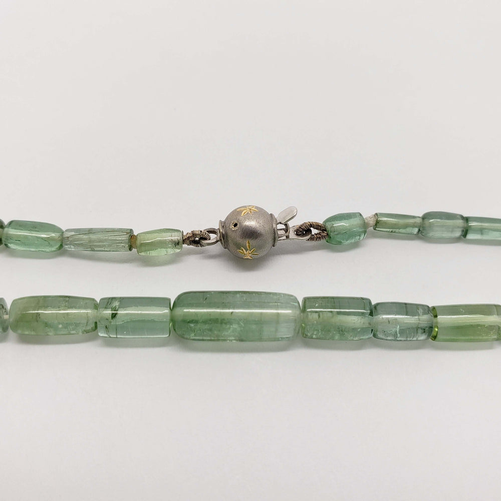 Detail of green tourmaline beads and white gold clasp with star engraving