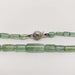 Detail of green tourmaline beads and white gold clasp with star engraving