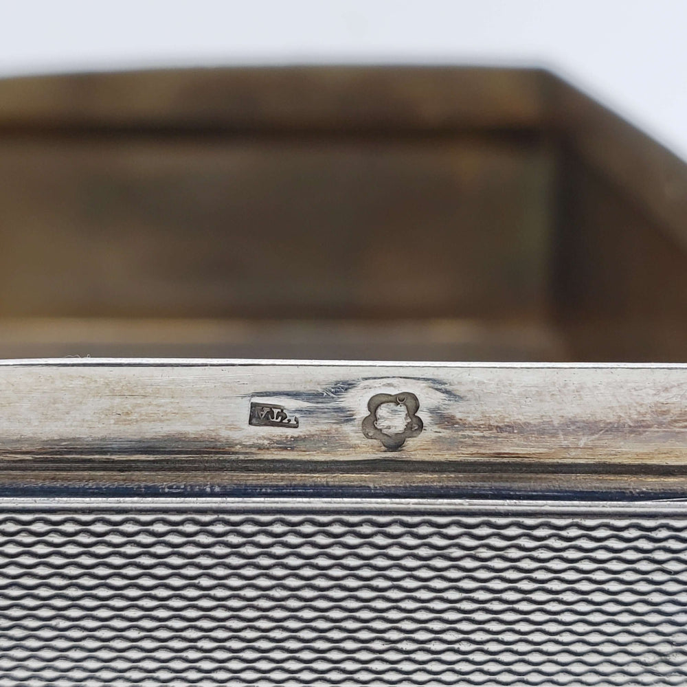 Detail of silver hallmarks stamped inside the antique cigar box