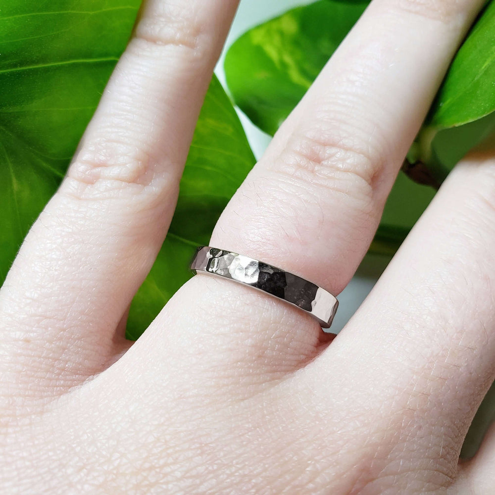 Hammered 14k white gold wedding ring worn on hand