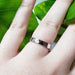Hammered 14k white gold wedding ring worn on hand