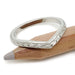 Hand engraved 14kt white gold chevron ring resting on a pencil, wheat pattern visible