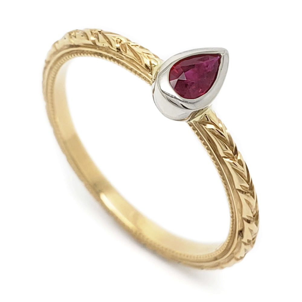 Hand engraved 14kt yellow gold ring with pear-shaped ruby in white gold bezel