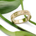 Hand engraved 14kt yellow gold wedding ring with Canadian diamonds, on green leaves