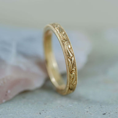 Hand engraved 14kt yellow gold wedding ring with curl and bead pattern, millgrain detail