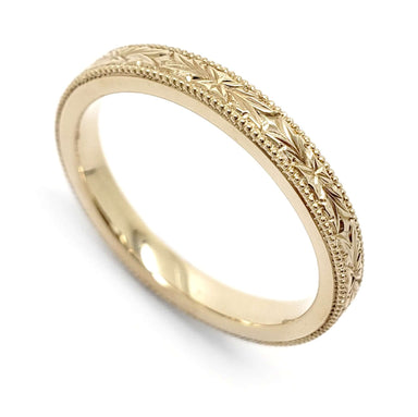 Hand engraved 14kt yellow gold wedding ring with floral and millgrain detailing