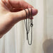 Hand holding blackened sterling silver box chain with clasp