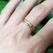 Hand wearing engraved 14kt yellow gold wedding ring with Canadian diamonds and floral design
